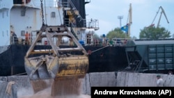 Punëtorët ngarkojnë grurë në një port gruri në Izmail, Ukrainë, më 26 prill 2023.