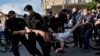 Police officers detain a protester during a rally in Minsk on June 19.