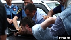 Armenia - Hayk Kyureghian is overpowered by police officers after firing gunshots outside a court in Yerevan, 12Jun2014.