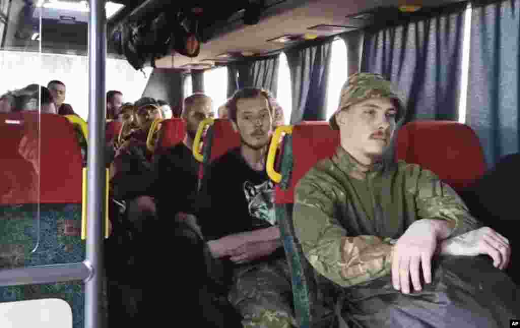 Ukrainian servicemen who were defending Mariupol's Azovstal steel plant sit in a bus after surrendering to pro-Russian forces on May 17. 