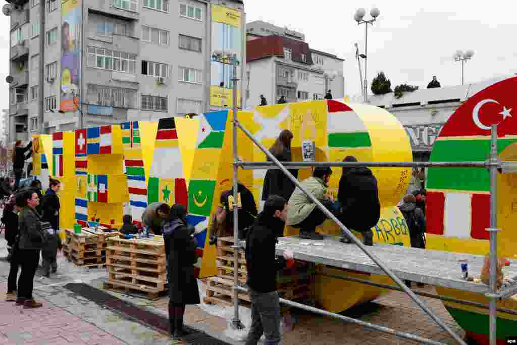 Kosovari boje spomenik postavljen povodom proglašenja nezavisnosti Kosova zastavama zemalja koje su priznale Kosovo, 16. februar 2013.