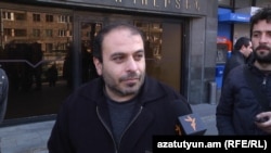 Armenia -- Andranik Gevorgian, an employee of the Yerevan metro, is interviewed by RFE/RL's Armenian service during a demonstration against pension reform, 12Feb2014.