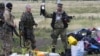 S-au împlinit ieri opt ani de la doborârea, de către separatiștii pro-ruși din Donbas, a avionului de pasageri Malaysia Airlines  (MH17) deasupra satului Hrabove, în Donețk, pe 17 iulie, 2014. Aici - luptător separatist arătând o jucărie găsită în resturile epavei avionului. 